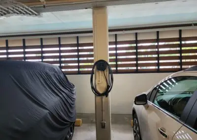 A car is parked in a garage with a cover on it.