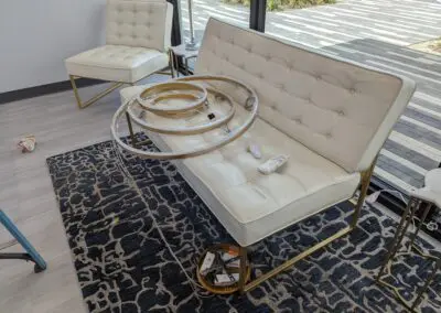 A living room with a white couch and a rug.