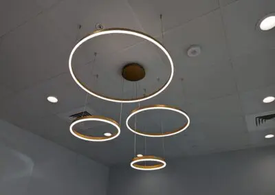 Three circular lights hanging from a ceiling in a room.